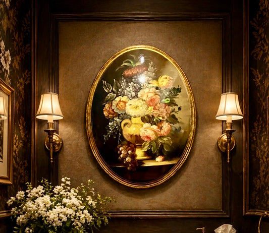 Decorative wall with floral painting, sconces, and flowers on a dark wall.