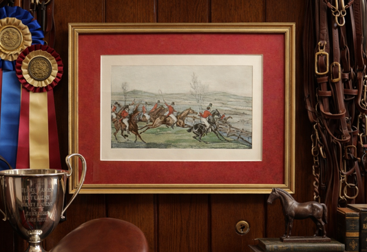 Framed artwork of a horse race on a red background with trophies and horse equipment.