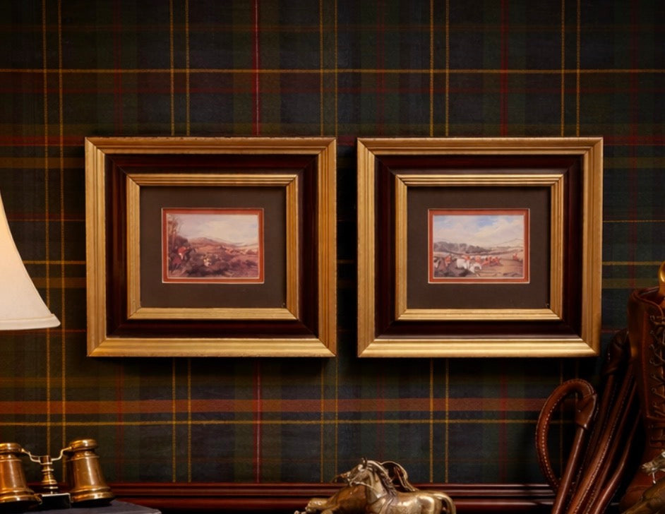 Two framed paintings on a wall with plaid wallpaper