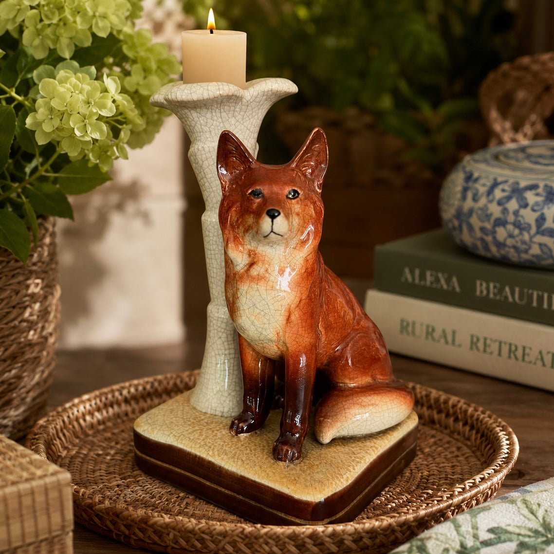 Ceramic fox figurine with a candle on a woven tray