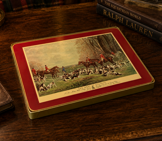 Decorative box with hunting scene illustration on a wooden surface