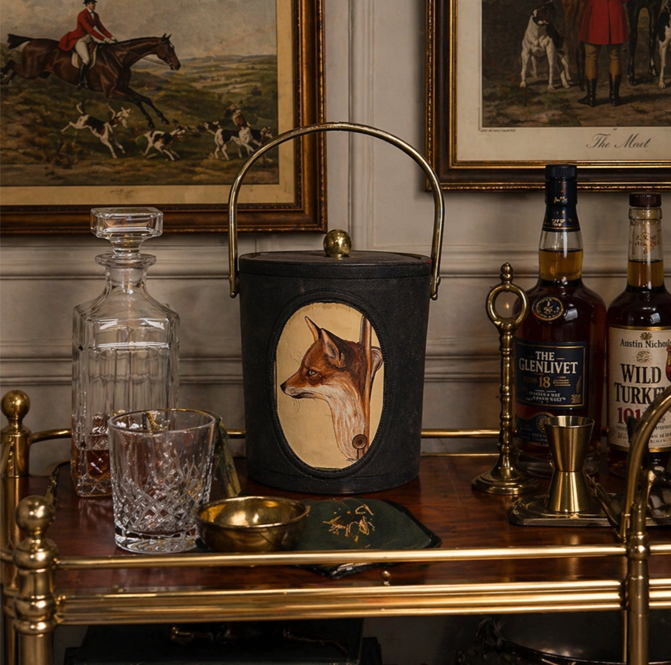 Decorative lantern with fox design on a bar cart with bottles and glasses.