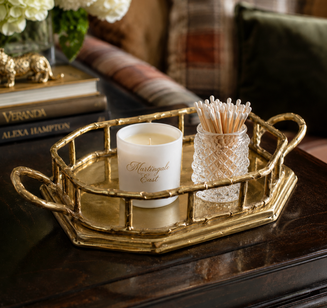 Decorative tray with a candle and toothpicks on a wooden surface