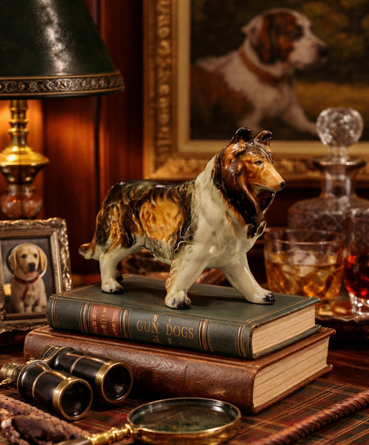 Dog figurine on books with a painting of a dog in the background