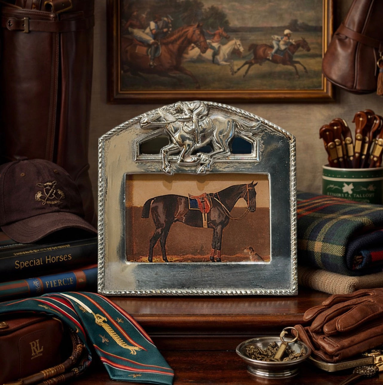 Decorative frame with horse design on a shelf with equestrian-themed items.