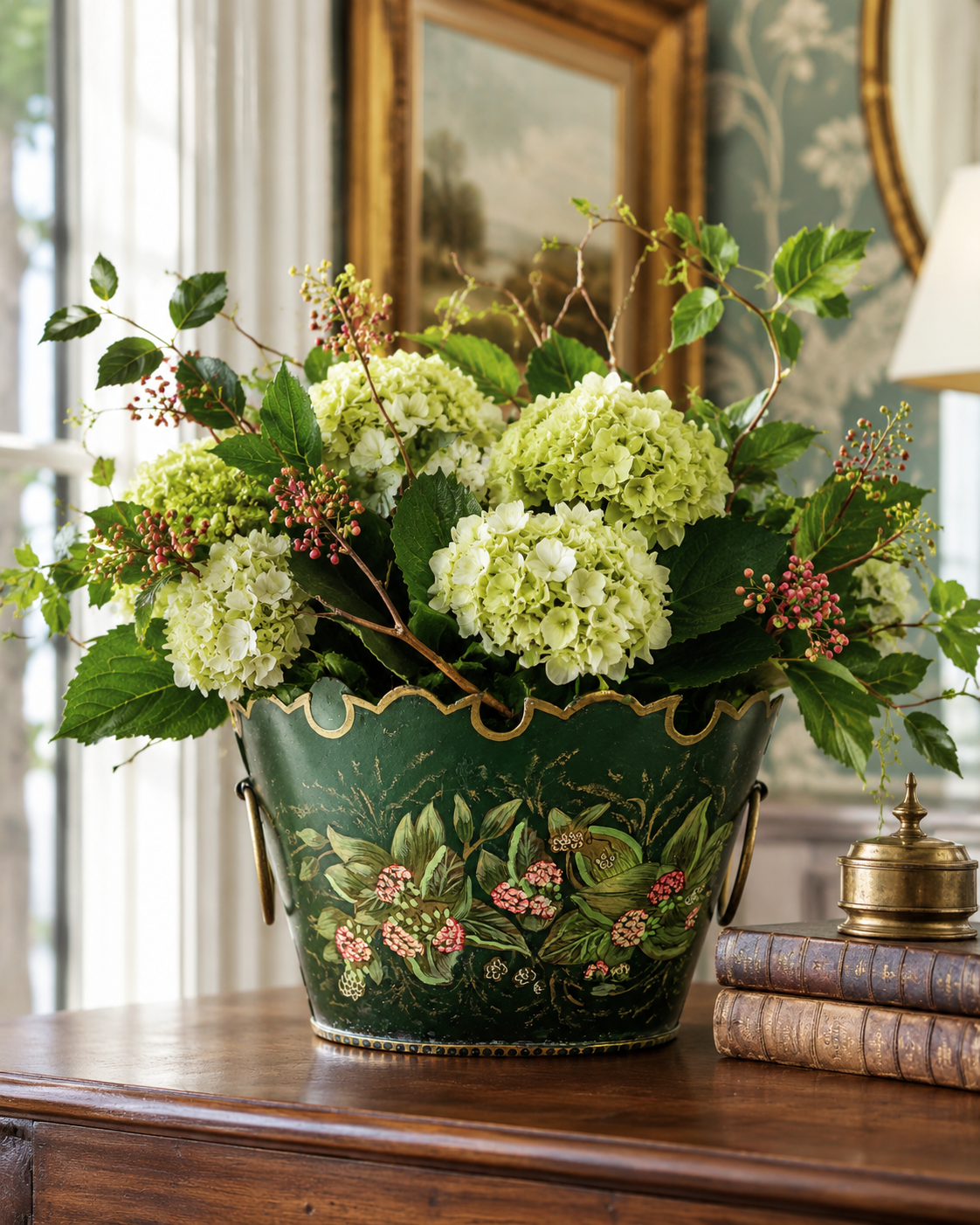 Decorative flower arrangement in a green floral-patterned pot on a wooden surface.