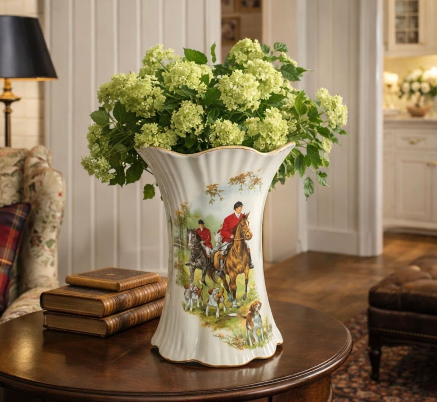 Decorative vase with a hunting scene on a table in a home setting
