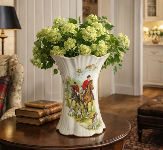 Decorative vase with a hunting scene on a table in a home setting